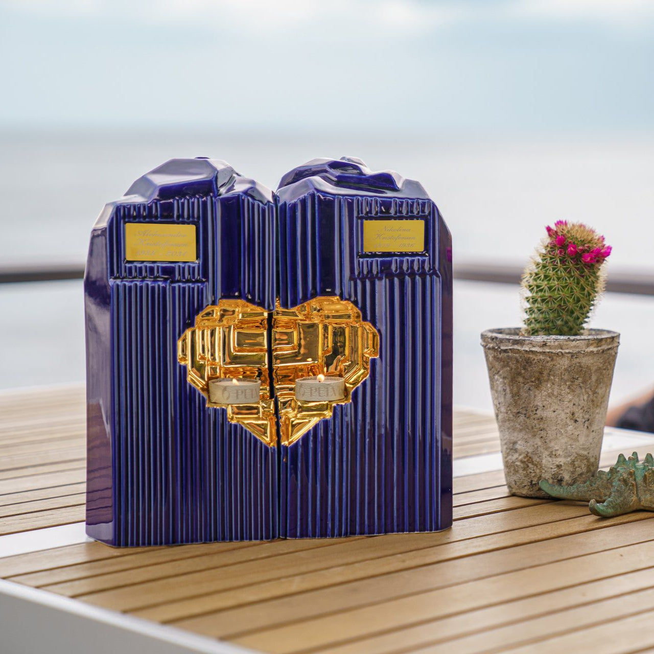 Blue cremation companion urn with heart design on a table outdoors