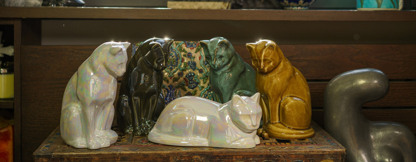Cat Urns for Ashes by Pulvis Art Urns. A photo of several Cat Urns from the models Neko and laying Cat. 