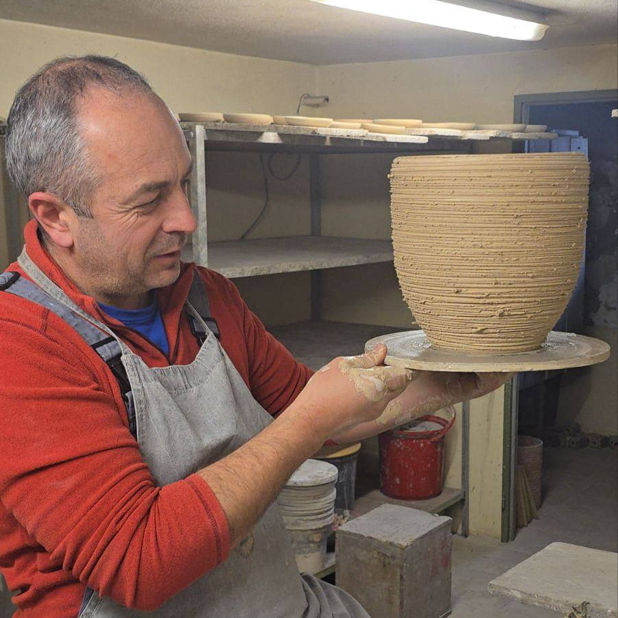 Man working with pottery in a workshop